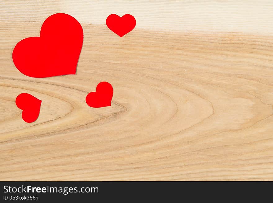 Beautiful red hearts on a background of wood