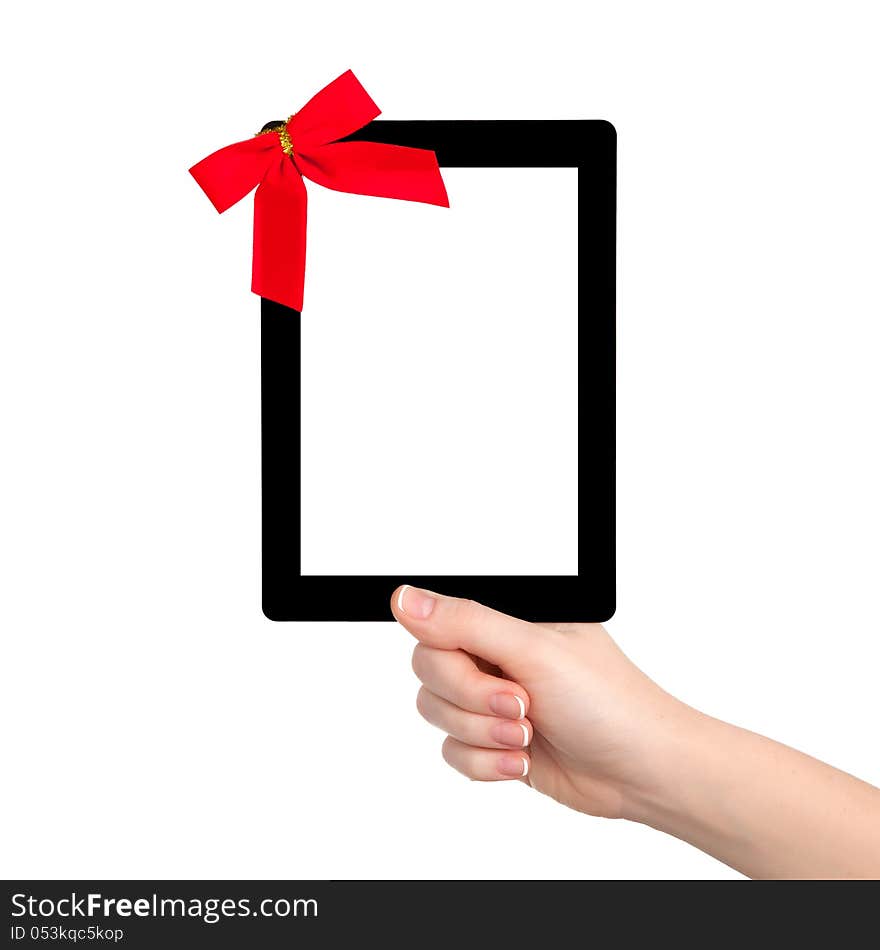 Female hands holding a tablet touch computer gadget with isolated screen and a red gift bow. Female hands holding a tablet touch computer gadget with isolated screen and a red gift bow