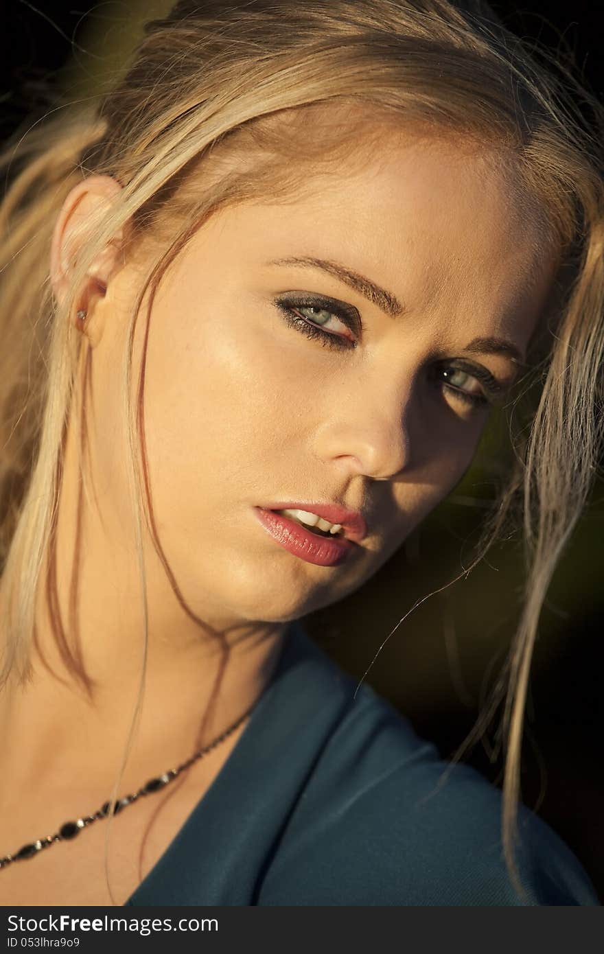 Portrait of a young woman staring straight ahead into the camera. Portrait of a young woman staring straight ahead into the camera