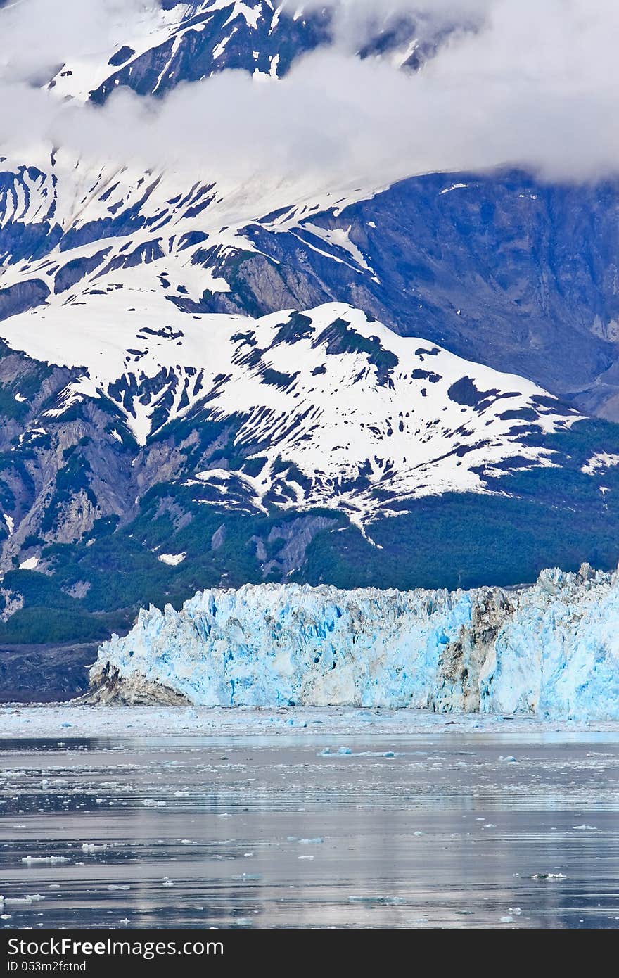 A view of icebergs in Disenchantment Bay, with Hubbard Glacier and the St. Elias Mountains in the background in Alaska. Hubbard Glacier is the largest tidewater glacier in North America, and a highly popular destination and attraction for cruise ships touring Alaska. A view of icebergs in Disenchantment Bay, with Hubbard Glacier and the St. Elias Mountains in the background in Alaska. Hubbard Glacier is the largest tidewater glacier in North America, and a highly popular destination and attraction for cruise ships touring Alaska.