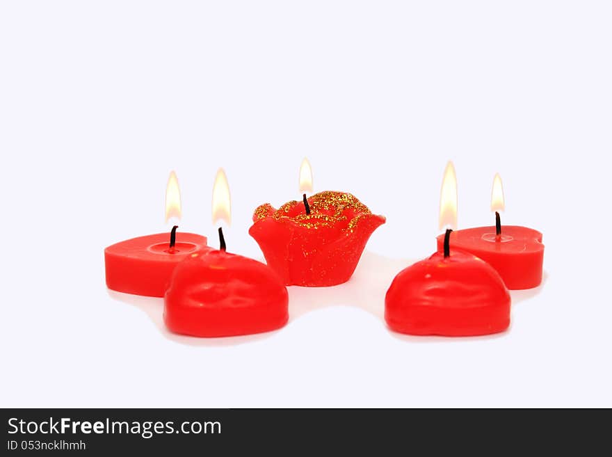 Red candles on grey background.