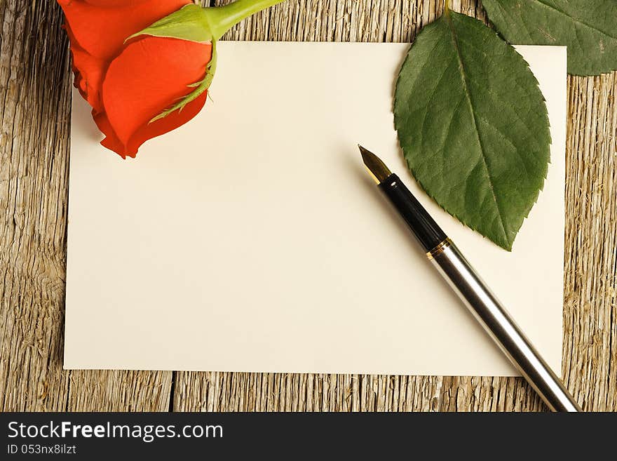 Blank card and a red rose