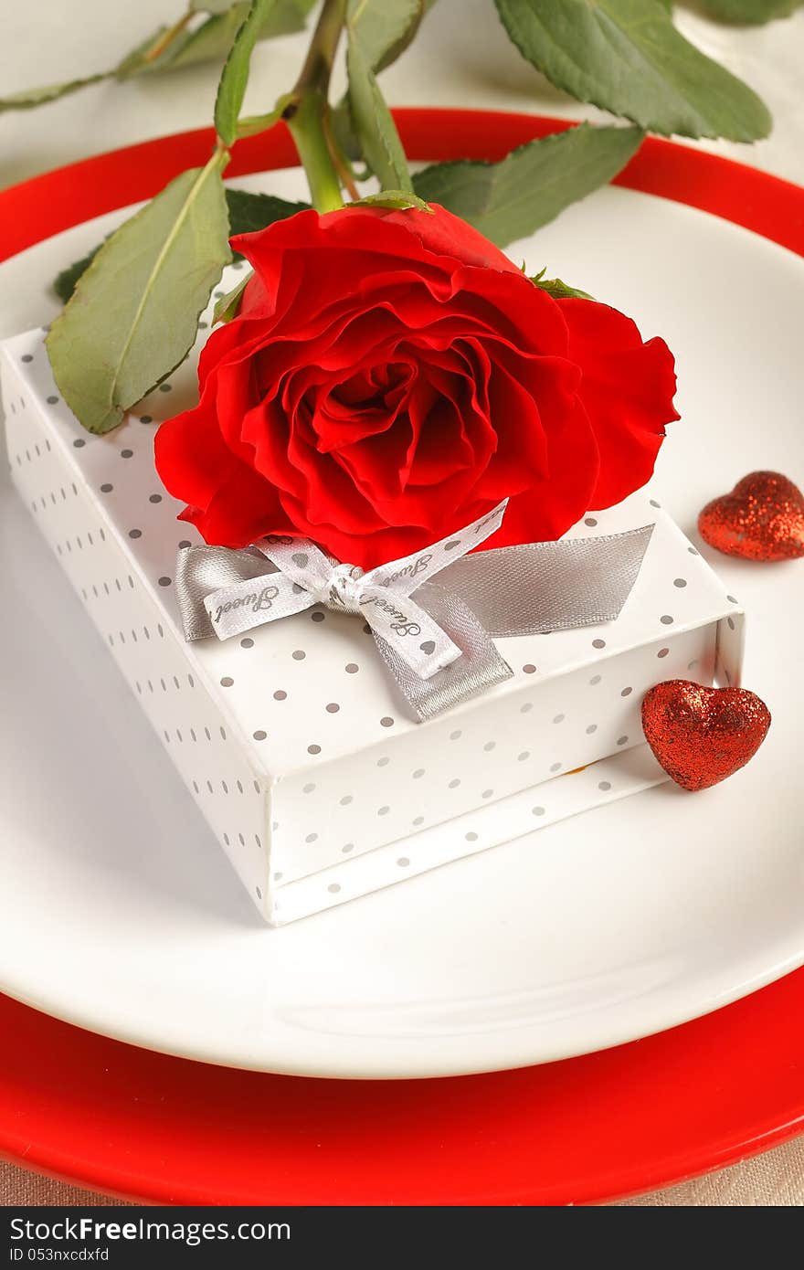 Romantic dinner setting with a rose and gift box. Romantic dinner setting with a rose and gift box