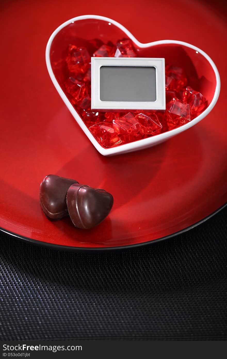 Red glass heart on a plate. Photo Frame inside heart. Red glass heart on a plate. Photo Frame inside heart