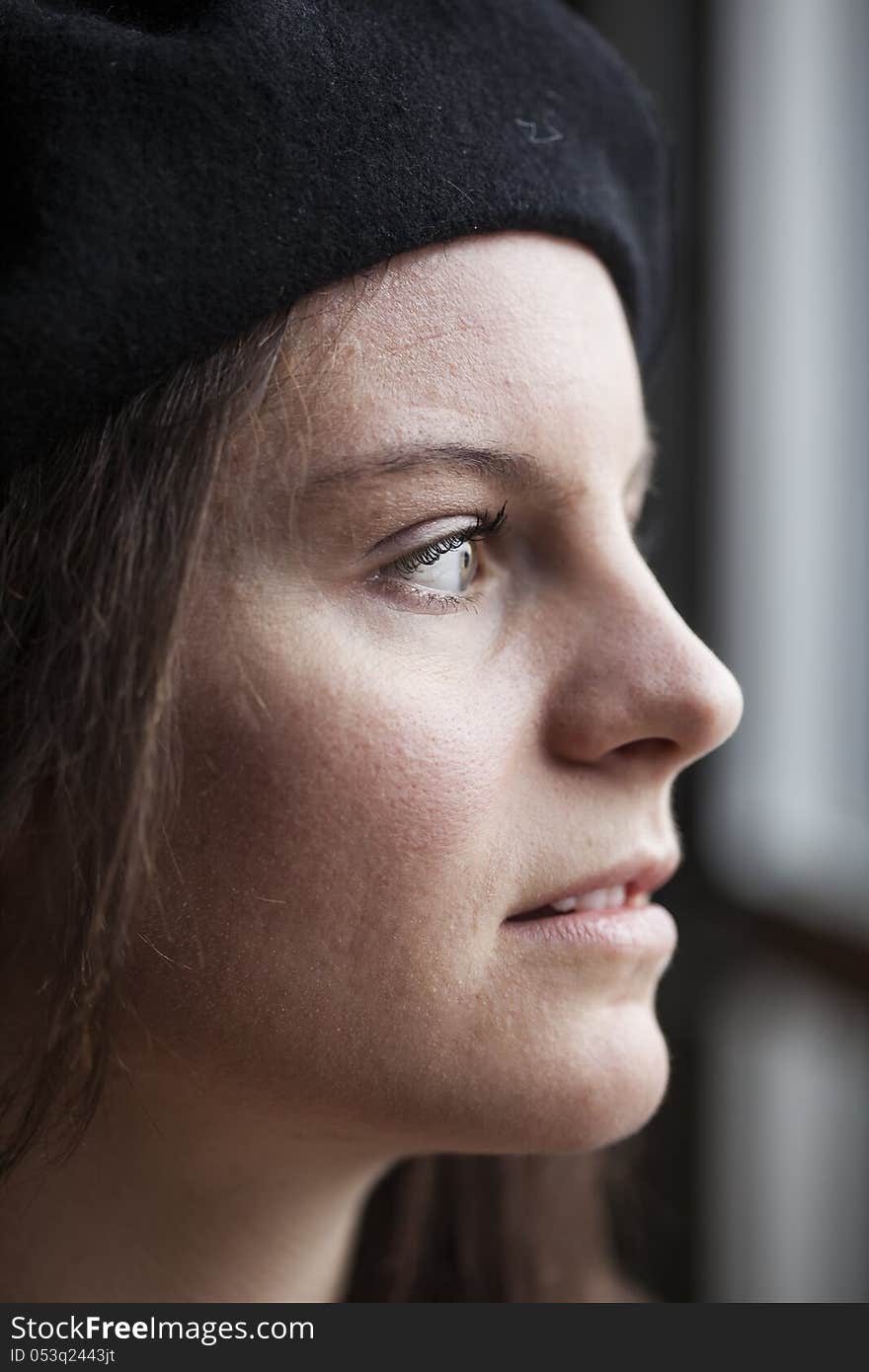 Portrait of a young woman staring straight ahead into the camera. Portrait of a young woman staring straight ahead into the camera