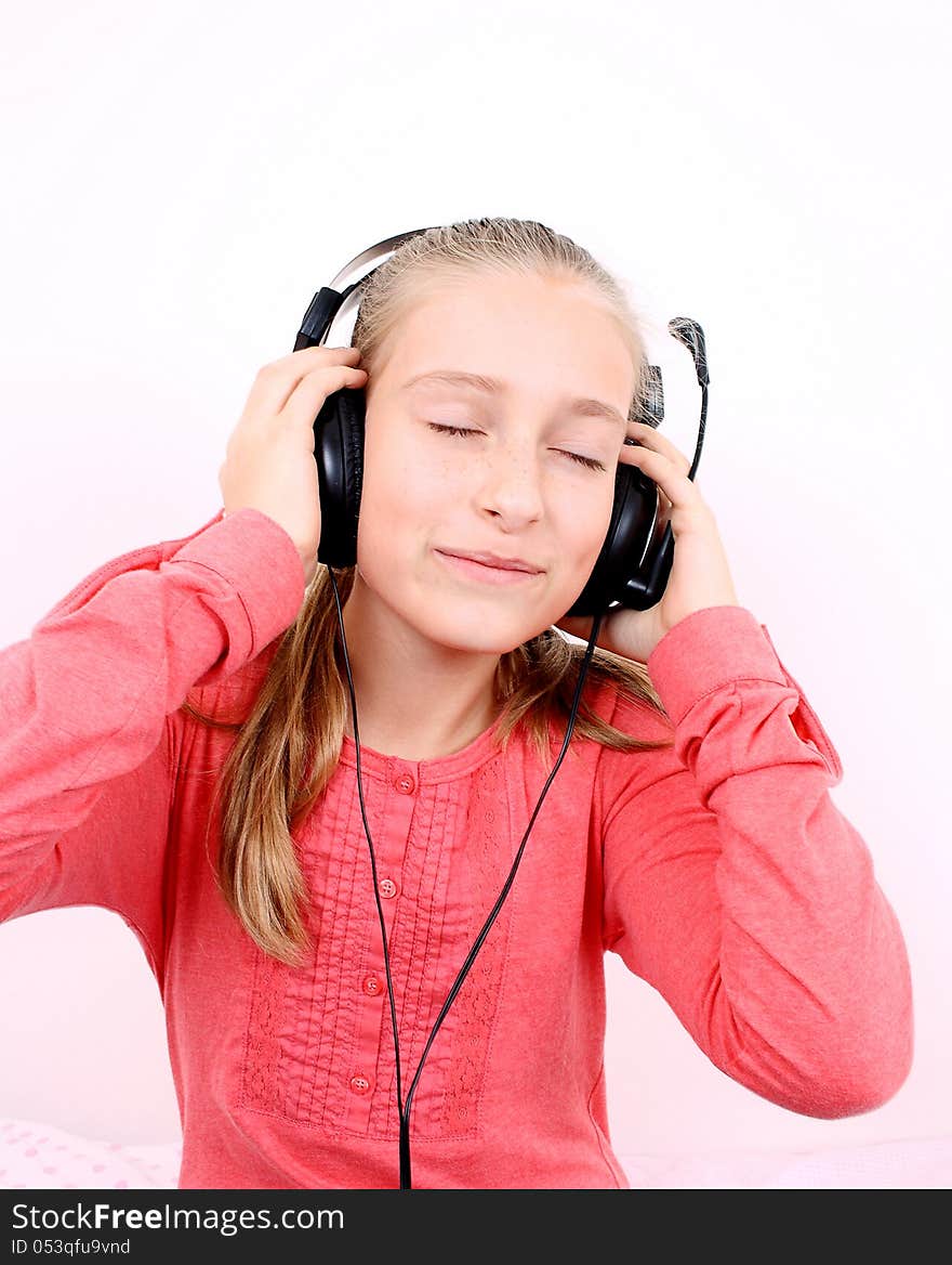 Blond happy girl listening to music with headset