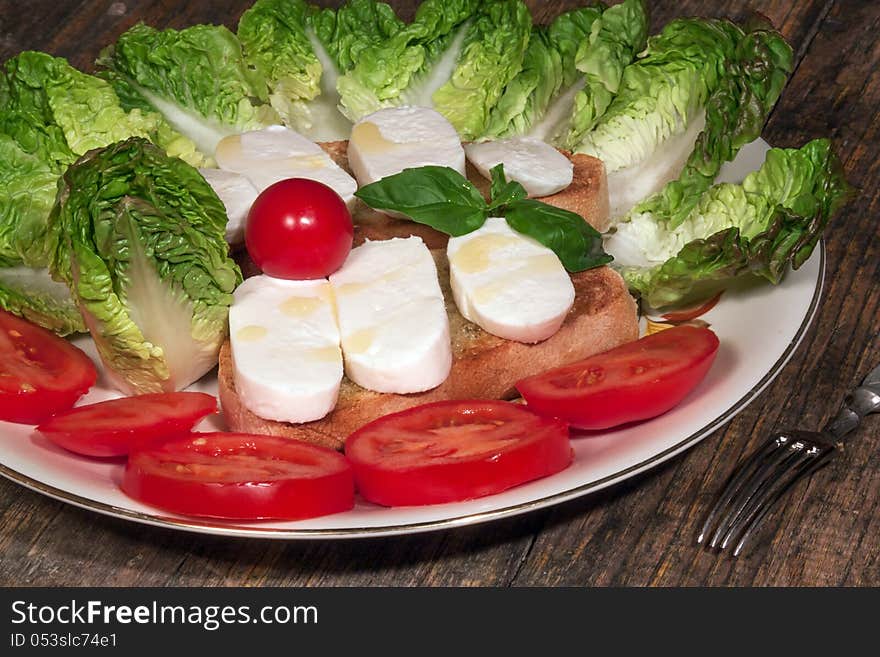 Close up of mozzarella tricolore salad with tomatoes and basil with drizzling. Close up of mozzarella tricolore salad with tomatoes and basil with drizzling