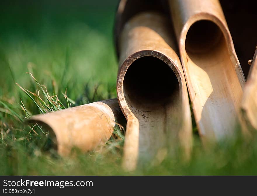 Chinese bamboo wind chimes lying on grass. Chinese bamboo wind chimes lying on grass