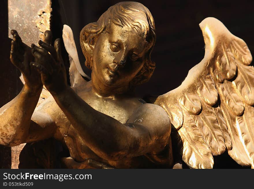 Figure of a praying angel in the cemetery