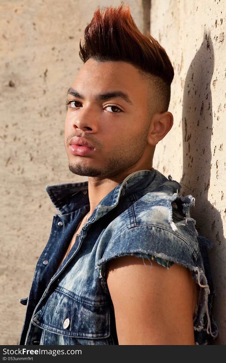 A portrait of an attractive young man outside, looking tough. A portrait of an attractive young man outside, looking tough