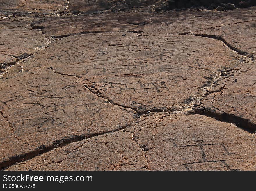 Native Hawaiian petroglyph pictograph carvings of symbols and figures in solidified lava. Native Hawaiian petroglyph pictograph carvings of symbols and figures in solidified lava.