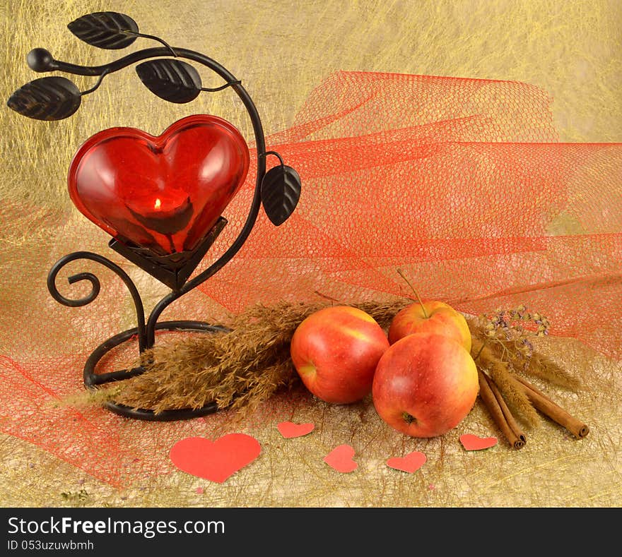 Red candlestick with apples and paper hearts. Red candlestick with apples and paper hearts