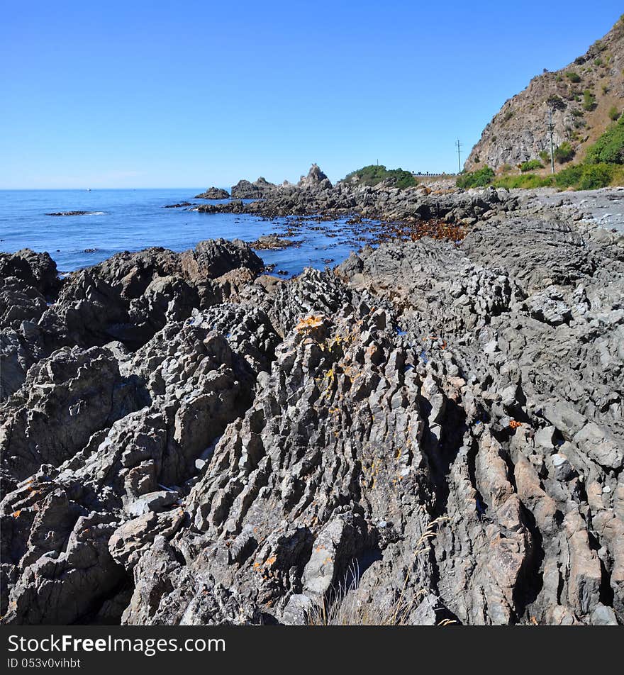 Vertical panoramic view of the rocky coastline of Kaikoura - a popular seal colony and whale watching tourist destination on the east coast of the South Island in New Zealand. Vertical panoramic view of the rocky coastline of Kaikoura - a popular seal colony and whale watching tourist destination on the east coast of the South Island in New Zealand.