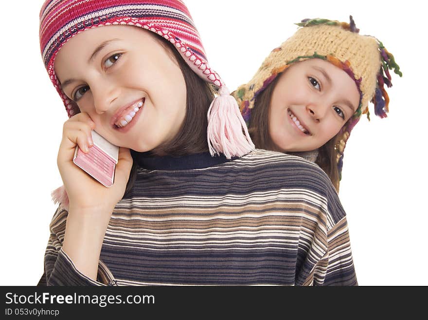 Beautiful young girls in warm winter clothes speaking on a mobile