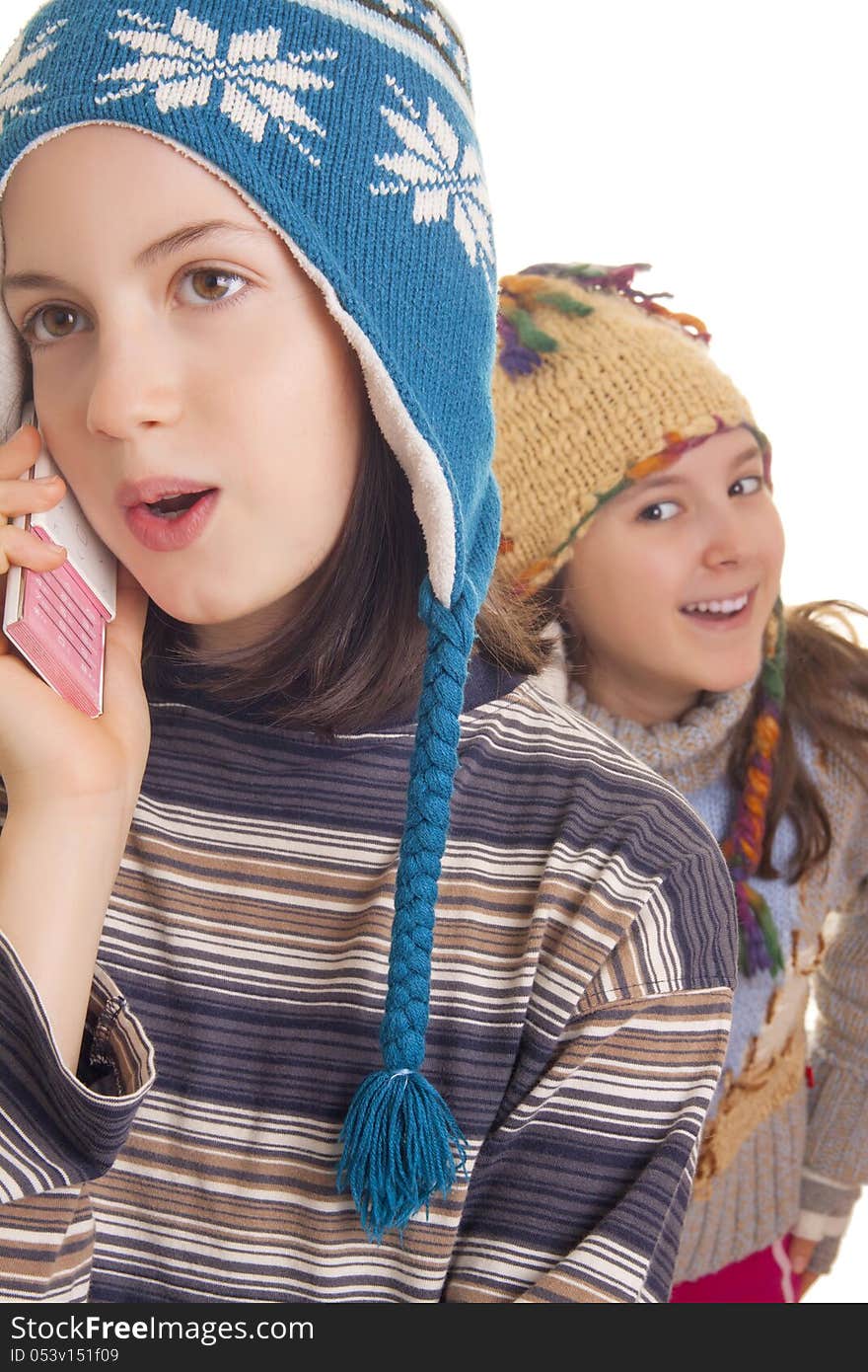 Beautiful young girls in warm winter clothes speaking on a mobile