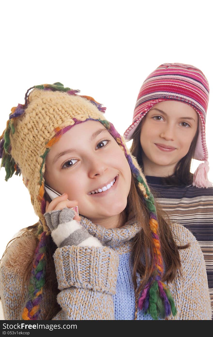 Beautiful young girls in warm winter clothes speaking on a mobile