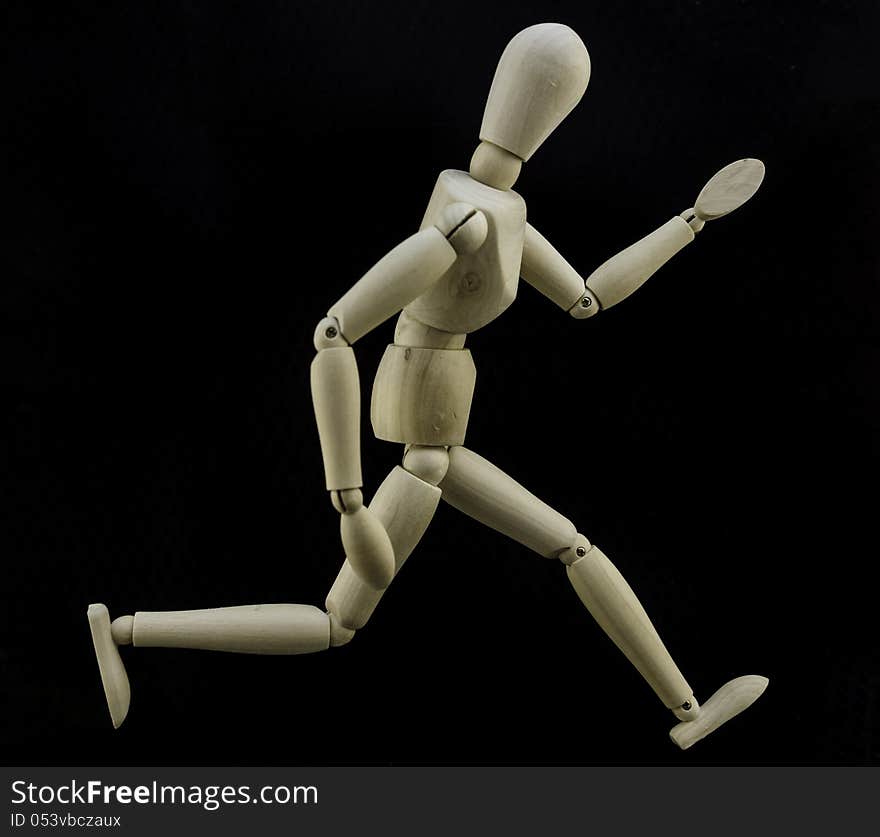 Wooden doll in a fast run. Wooden doll in a fast run