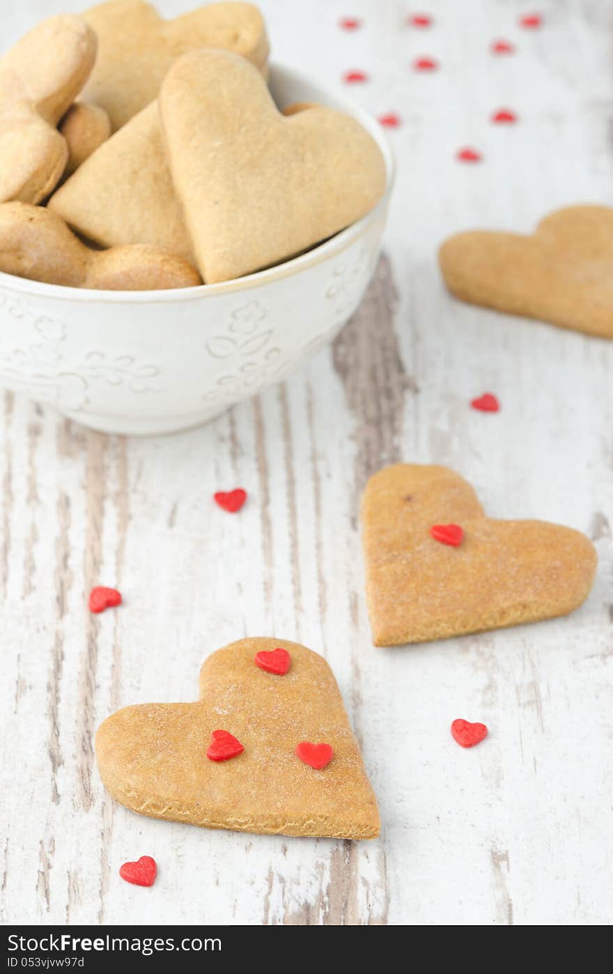 Heart shaped cookies on the table and a bowl of cookies