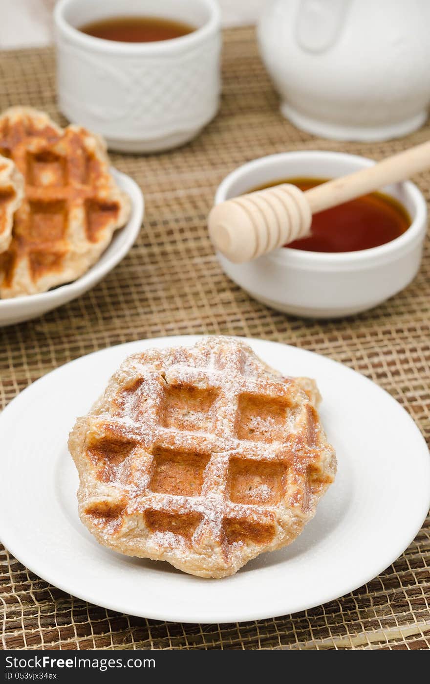 Homemade waffles topped with powdered sugar for breakfast