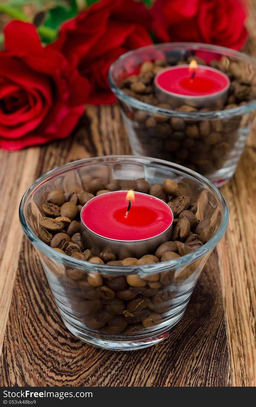 Red candles in glass jars with coffee beans