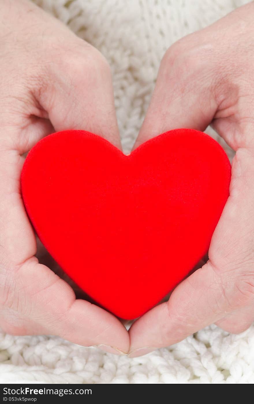 Red Heart In The Hands Of Men Closeup