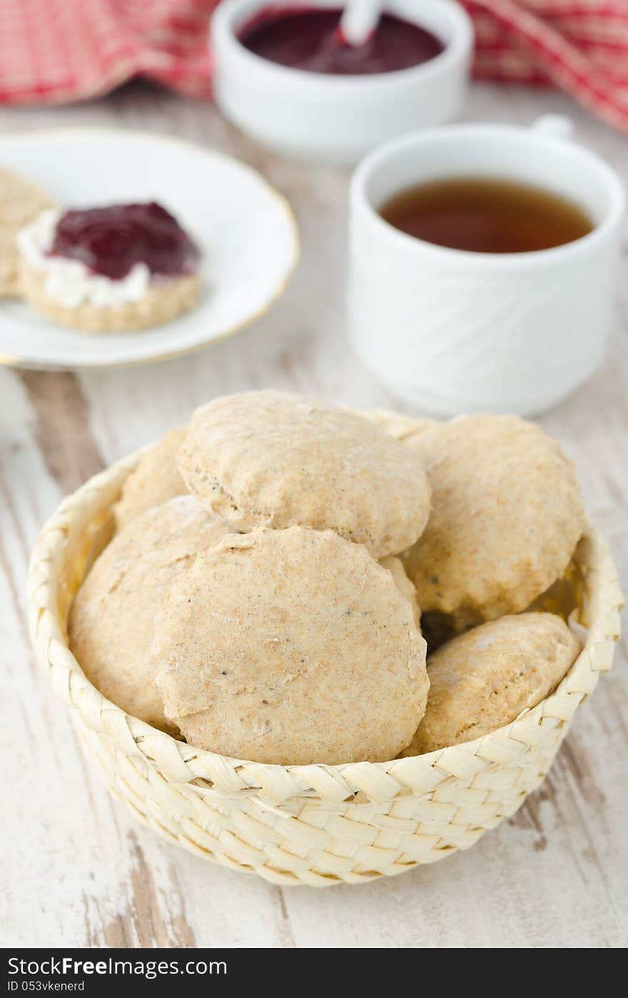 Scone of whole wheat in a wicker basket vertical