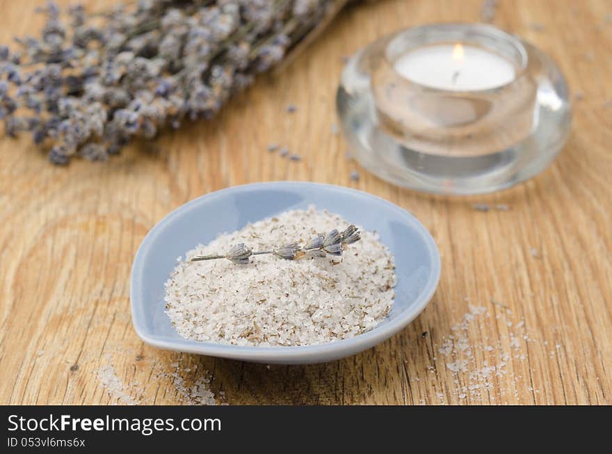 Sea salt with lavender and candle on wooden table