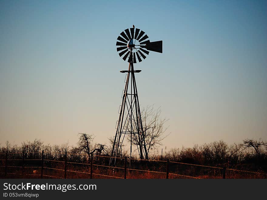 Bared Wire Fence And Water Windmill