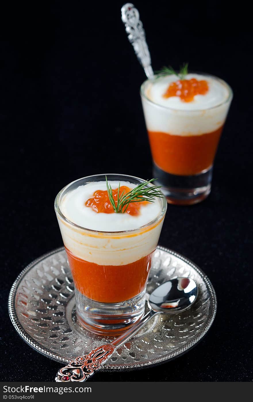 Two appetizers in a glass goblet of sweet pepper, cream and red