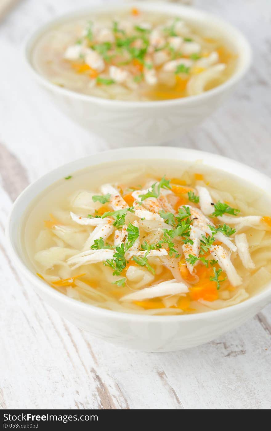 Two Bowls Of Vegetable Soup With Chicken And Parsley