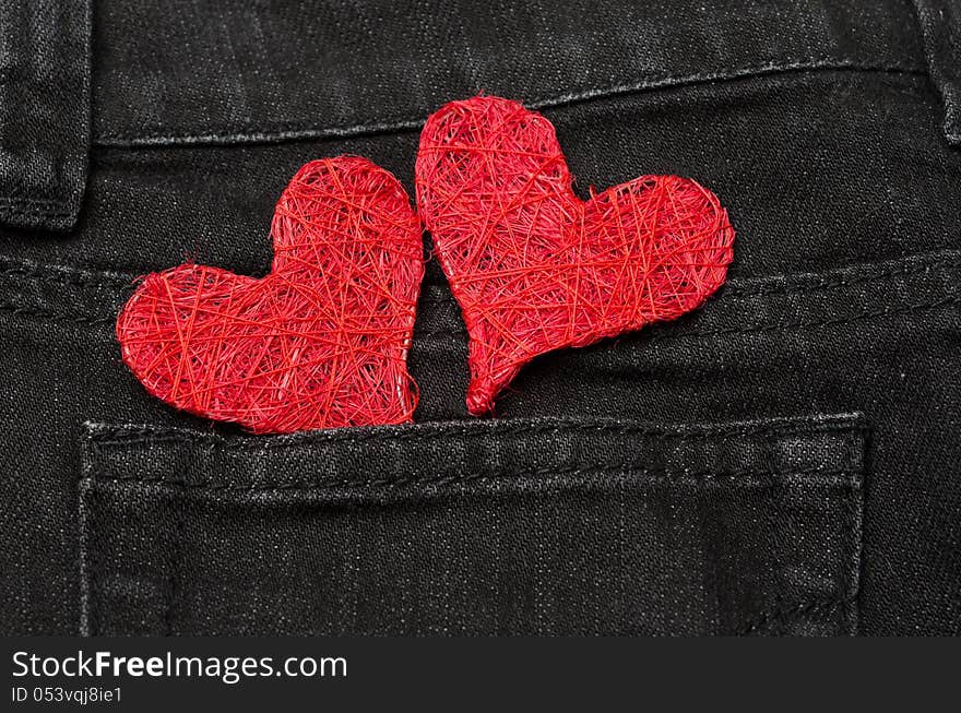 Two red hearts in a pocket black jeans