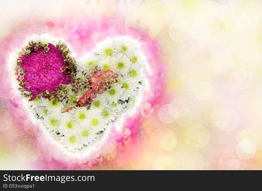 Heart of flowers with a blurred background as a Valentine's card. Heart of flowers with a blurred background as a Valentine's card