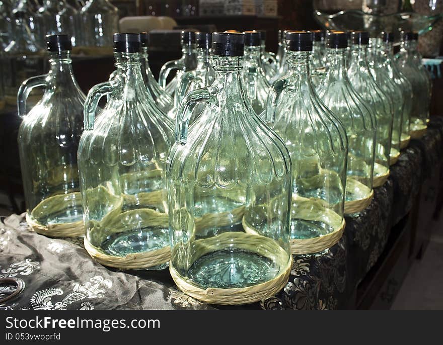 Large glass bottles prepared for bottling olive oil