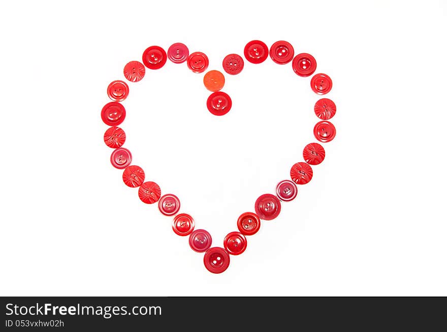 Heart from red buttons on a white background