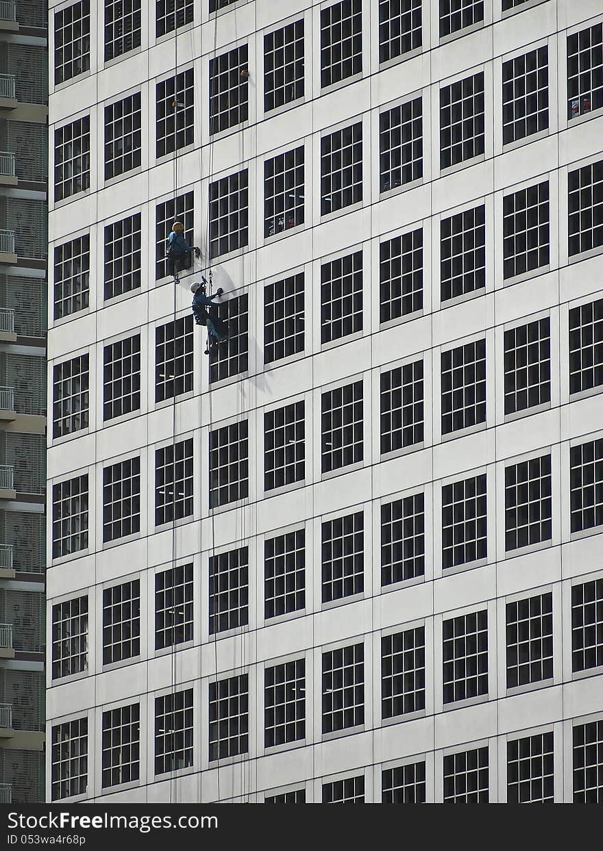 Two worker climb for cleaning outside high building. Two worker climb for cleaning outside high building