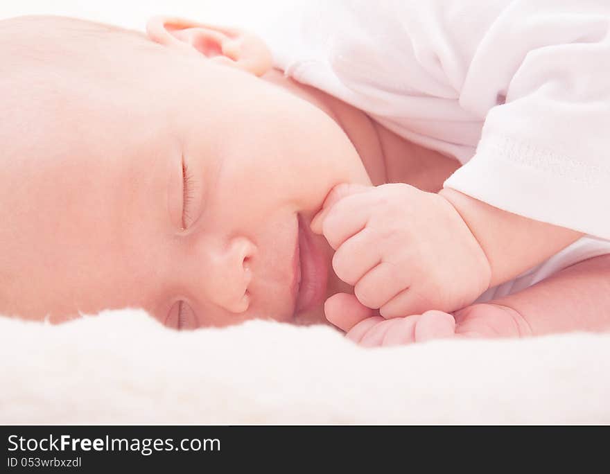 Smiling face of newborn baby sleeping