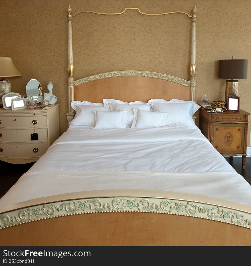 Interior of a modern bedroom. Bed, bedside tables, pillows.