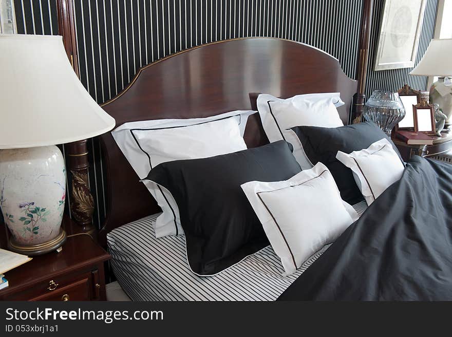 Interior of a modern bedroom. Bed, bedside tables, pillows.