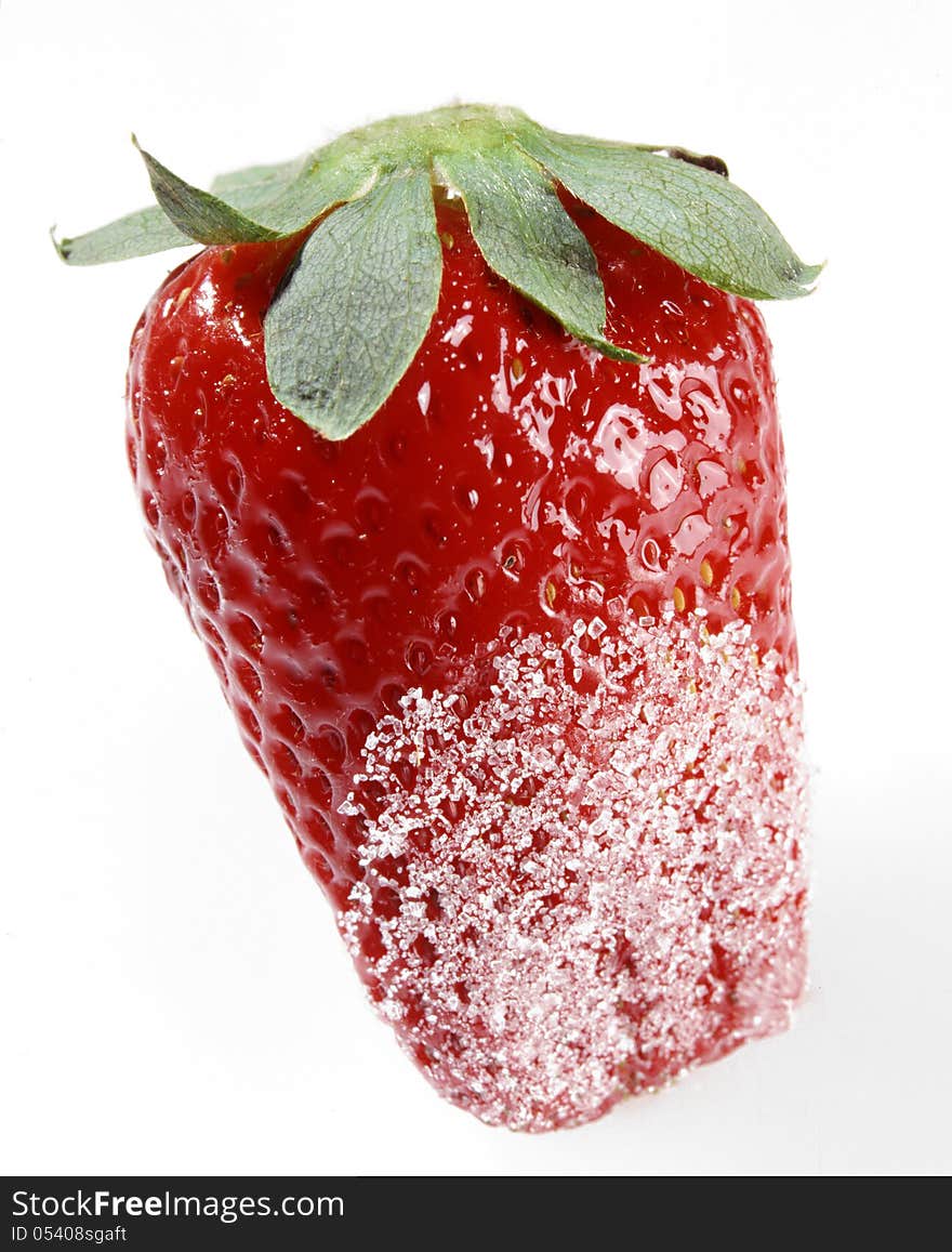 Closeup of a luscious fresh whole ripe red strawberry dipped in sugar with part of the green stem isolated on white. Closeup of a luscious fresh whole ripe red strawberry dipped in sugar with part of the green stem isolated on white