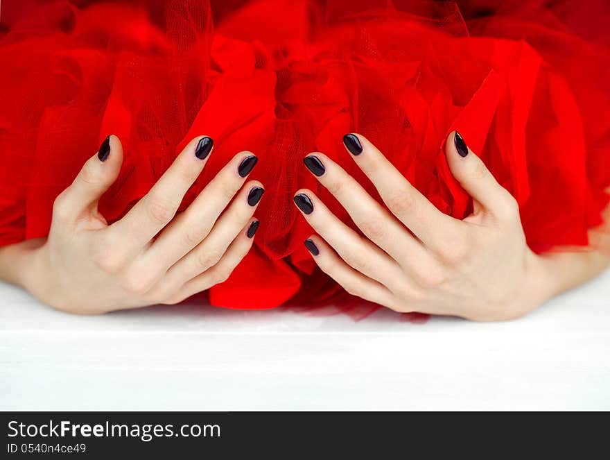 Hands With Dark Manicure And Red Veiling