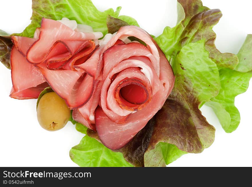 Arrangement of Jamon and Greens with Olive closeup on white background. Top View