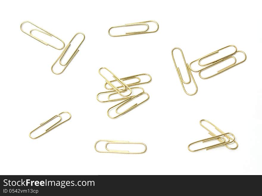 A group of isolated brass paperclips from different angles. A group of isolated brass paperclips from different angles