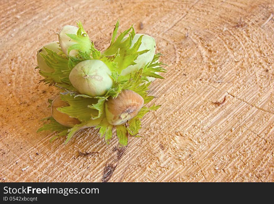 Fresh green hazelnut on  brown background