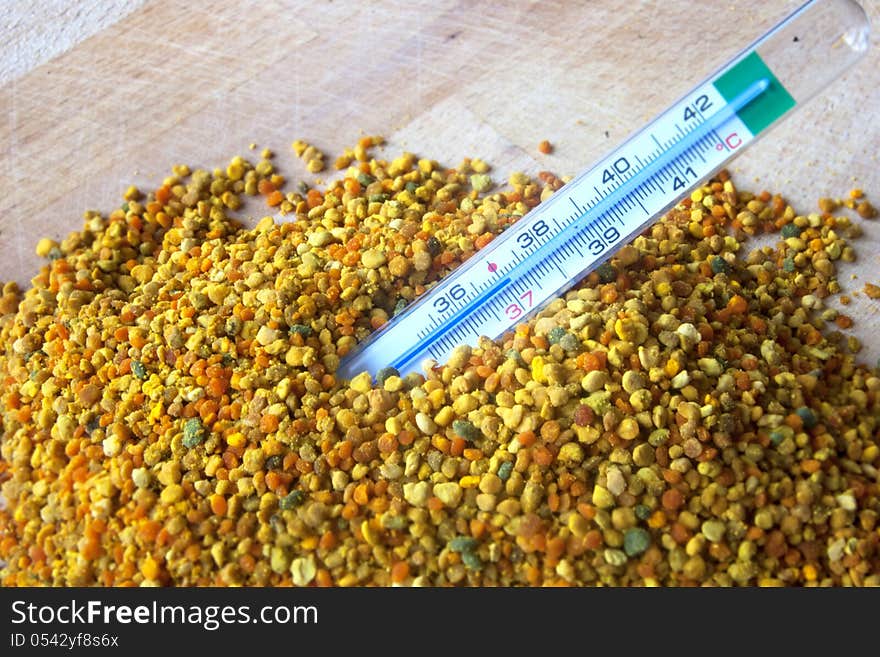 Pollen grain used in natural treatment with thermometer. Pollen grain used in natural treatment with thermometer