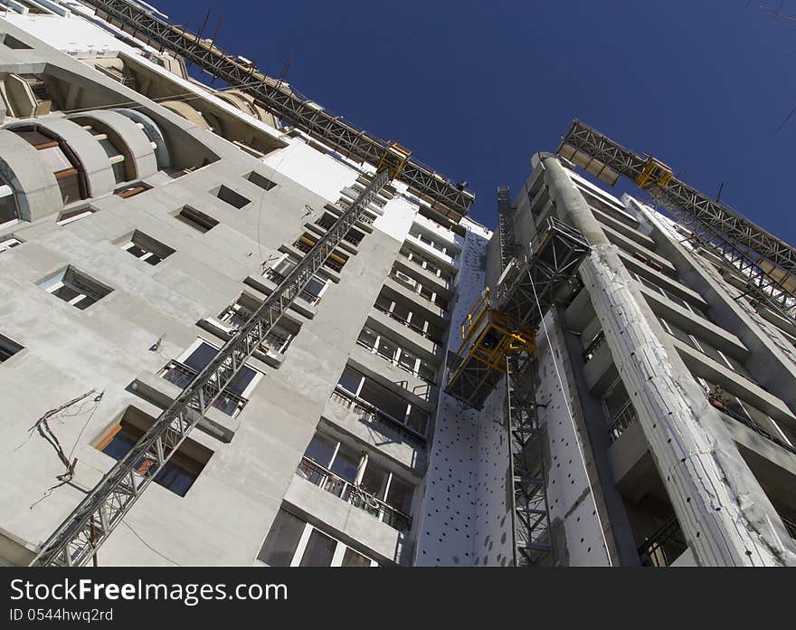 Scaffold elevators and a buiding being constructed. Scaffold elevators and a buiding being constructed