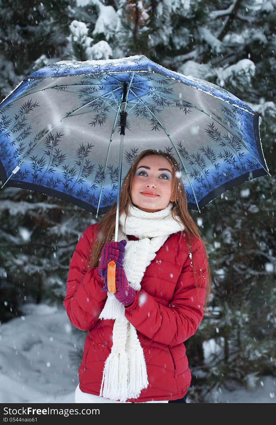 Beautiful, cute woman standing under an umbrel