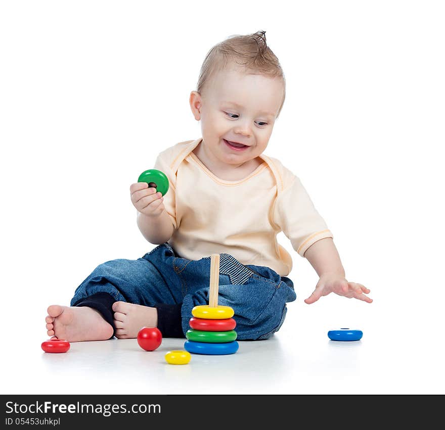 Happy baby boy playing with colorful toy on white