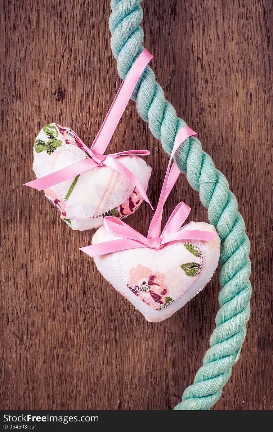 Valentine Hearts Hanging On Rope On Wooden Background