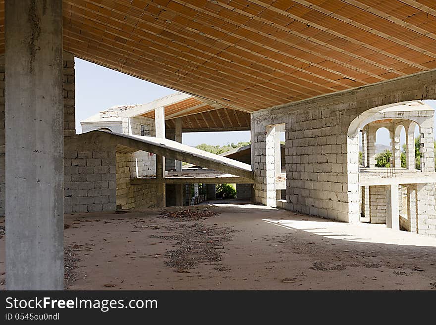 House under construction with reinforced concrete columns and concrete blocks.
Inside the building, you see bricks, pillars and concrete blocks. House under construction with reinforced concrete columns and concrete blocks.
Inside the building, you see bricks, pillars and concrete blocks.