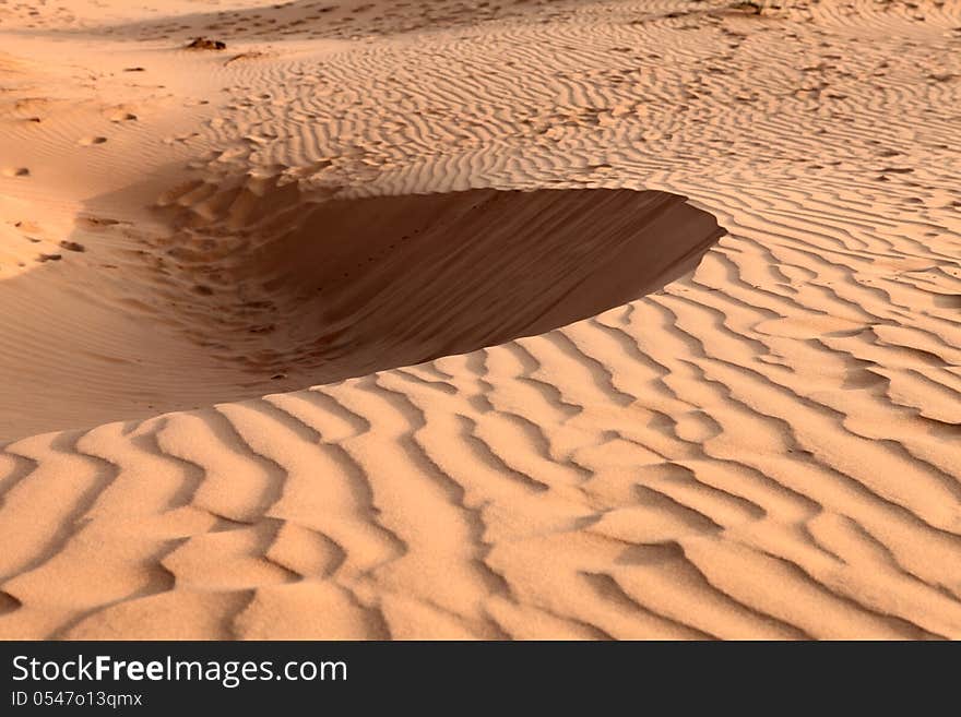 Red sand dunes on sunset. Pattern